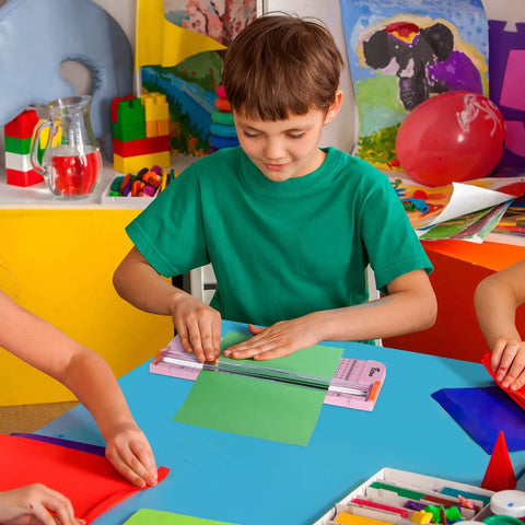 Child using 12 Inch Titanium Paper Cutter With Side Ruler For Scrapbooking And Crafting No Fuss Paper Trimmer Guillotine