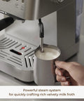 Compact Espresso Machine With 20 Bar Pressure And Digital Temp Display Built In Milk Frother steaming milk for lattes.