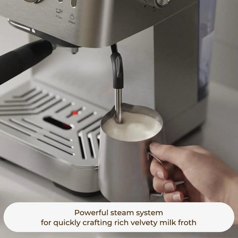 Compact Espresso Machine With 20 Bar Pressure And Digital Temp Display Built In Milk Frother steaming milk for lattes.