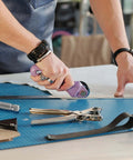 Knife blade and drive housing for Maker 3; purple handheld rotary cutter on a blue cutting mat.