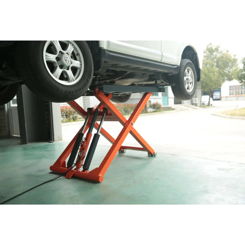 Portable Mid Rise Scissor Lift With 6600 Pound Capacity And 55 Inch Max Lift Height Shop Grade hydraulic jack lifting a vehicle for maintenance.