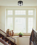 Three Light Rustic Modern Flush Mount Ceiling Light in dark bronze with brass details, clear glass shade in stairway.