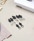 12 Pack Black Universal Zipper Repair Kit Instant Fix Replacement Sliders for sewing projects, next to sewing tools.