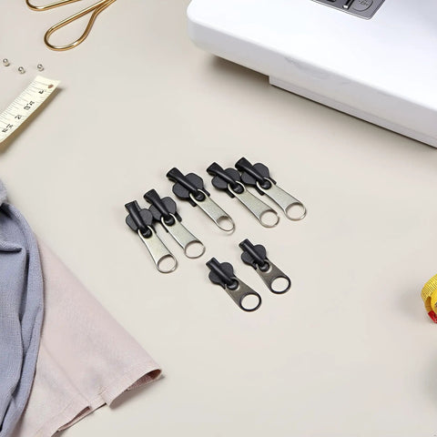 12 Pack Black Universal Zipper Repair Kit Instant Fix Replacement Sliders for sewing projects, next to sewing tools.