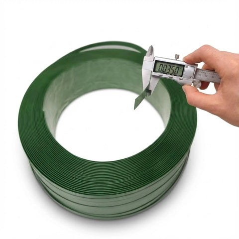 Heavy Duty Green Polyester Strapping Roll For Solid Pallet Securing 5/8 Inch Wide By 4000 Feet Long being measured with calipers.