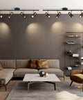 Modern living room with 4 Lights Matte Black Track Lighting Fixture For Ceiling, adjustable heads highlight seating area.