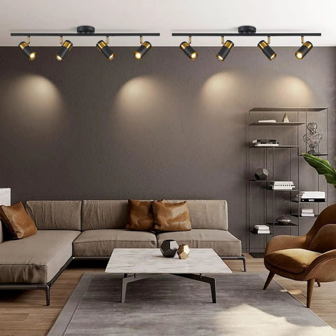 Modern living room with 4 Lights Matte Black Track Lighting Fixture For Ceiling, adjustable heads highlight seating area.