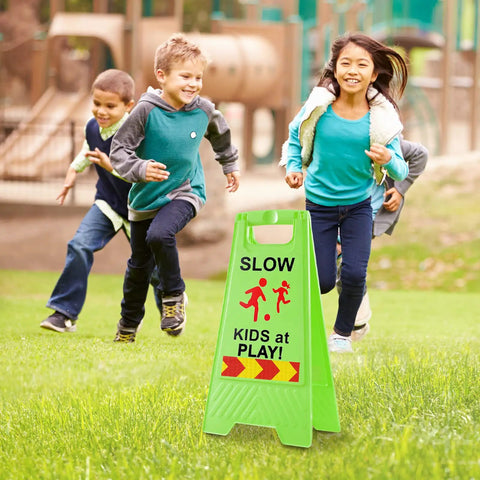 Slow Kids At Play Signs For Street Double Sided With Reflective Tape High Visibility Children At Play Safety Sign For Neighborhoods Schools Parks Sidewalks And Driveways 2 Pack Green on grass with children playing