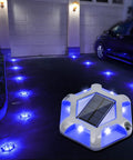 Solar Dock Lights For Driveways And Walkways 12 Pack Waterproof Aluminum LED Hexagon Step Lights in blue illuminating a driveway.