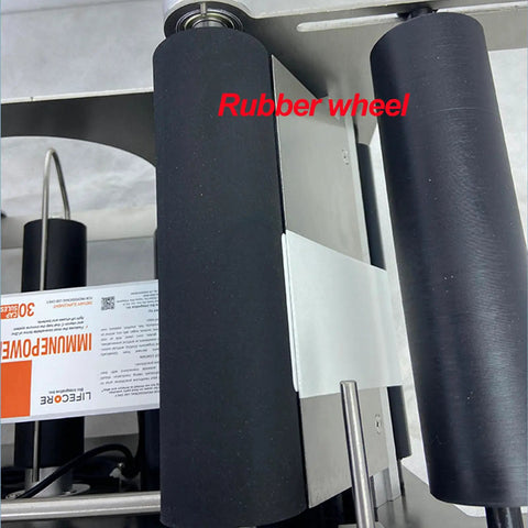 Smooth Operator Semi Automatic Round Bottle Labeler rubber wheel mechanism showing precision components for efficient labeling.