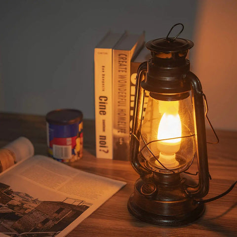 Pack Of 2 Vintage Rustic Lantern Lamps With Edison LED Bulbs, Bronze Rust Finish on a wooden desk near books