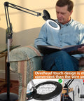 Man using 10X Floor Magnifying Glass With Light And Stand, Ultra Bright 2200 Lumens LED Magnifier next to a couch
