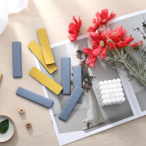 Eight Piece Premium High Density Self Adhesive PTFE Rectangle Furniture Glides on a wooden surface with flowers and decor.