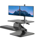 Standing Desk Converter With Dual Monitor Mount And Large Keyboard Tray, Sit Stand Riser in black, two monitors displayed