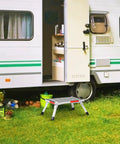 Beefy Heavy Duty Aluminum RV Steps Folding Platform Stool with anti-slip surface, reflective strips, and rubber feet next to RV.