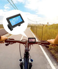 Cyclist using KT LCD3 Electric Bike Display Meter With Waterproof Plug For KT Controller 36V 48V 72V Conversion Kit on a road