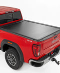 Rough Country powered aluminum retractable tonneau cover on a red GMC Sierra 2500HD pickup with 6'9 bed