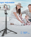 Family using the Go To 50 Inch Extendable Selfie Stick Tripod For Phones With Remote Shutter on a beach.