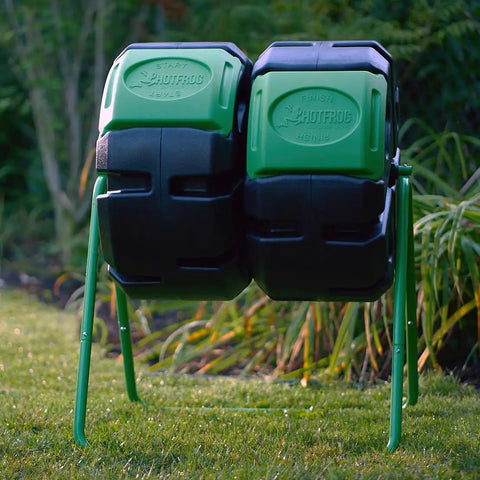37 Gallon Dual Chamber Tumbling Composter For Backyards in garden setting with green and black design, easy turn barrel.