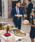 Eco Friendly Sugarcane Disposable Dinnerware Set with 250 pieces of compostable plates and utensils at a party setting