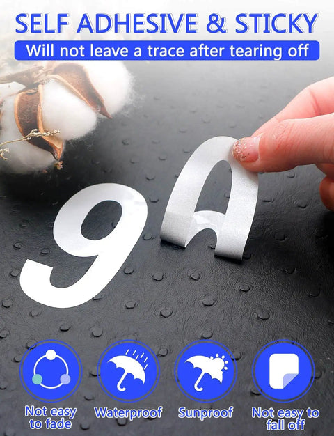 Hand peeling white vinyl reflective number and letter stickers on black dotted surface, showcasing Super Bright Reflective Mailbox Numbers And Letters Stickers In White For Outside Homes With Waterproof Vinyl Self Adhesive Decals That Stick Great On Mailboxes Doors Cars And Make Your Address Pop At Night.