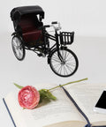 Absolutely Sweet Mini Motorcycle And Vintage Rickshaw Cake Topper With Detailed Metal Alloy Body, displayed next to a book and flower.