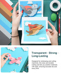 Hands holding cutout cards made with 4 Pack Transparent Die Cutting Pads For Scrapbooking Machines, 8.75 x 6 Inch Clear Polycarbonate Cutting Plates