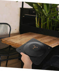 Heavy Duty Steel Table Leg Connectors To Kick The Wobble Out Of Wobbly Couches And Wooden Dining Tables Fast With No Sweat Install For Tough Home Reno Fixes, black cast iron bracket in hand.