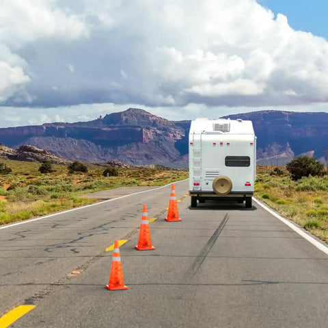 Camper on road with 28 Inch Collapsible Traffic Safety Cones Pack Of 4 With Reflective Collar, Ultra Visible Orange Pop Up Cones