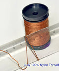 Heavy Duty Upholstery Repair Kit With Extra Strong Sewing Thread And Hand Needles Includes 5 Nylon Thread Spools 7 Styles Leather And Canvas Needles And 1 Needle Threader For Carpets Furniture Coats Tents Mattresses And Leather DIY Projects - close-up of 3-ply nylon thread spool with ruler, for heavy fabrics.