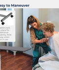 Heavy Duty Adjustable Overbed Table With Dead Simple Height Changes Non Tilt Wood Grain Top And Smooth Rolling Swivel Casters For Zero Hassle Room Moves with caregiver assisting patient.