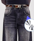 Front view of dark denim jeans adorned with silver 8 mm glue-on bullet cone studs along pockets.