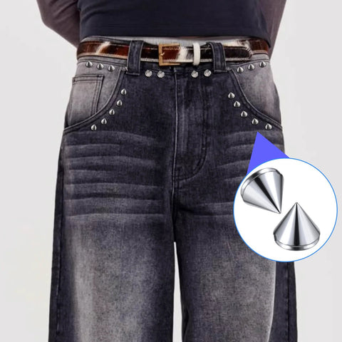 Front view of dark denim jeans adorned with silver 8 mm glue-on bullet cone studs along pockets.