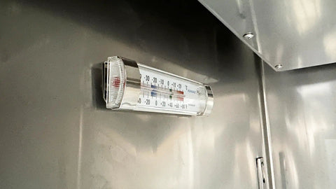 Digital thermometer installed in the Straight Up Tough Commercial Reach In Two Door Freezer with visible temperature scale.