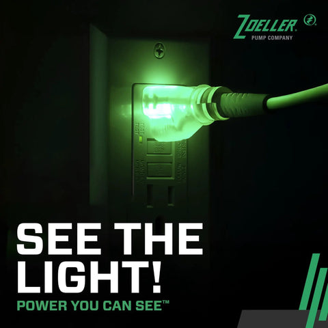 Green light illuminating a power outlet with a plug, showcasing power connection and visibility. Complete Sump Pump Setup With Tough One Half HP Motor And Smart 12 Volt DC Battery Backup Beats Rough Weather With Full Kit Check Valve Float Switch And PVC Pipes To Keep Basements Bone Dry While System Runs Smooth During Storms.