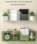 Organized caddy with books, clock, and plants in a green wall-mounted plastic storage for living room