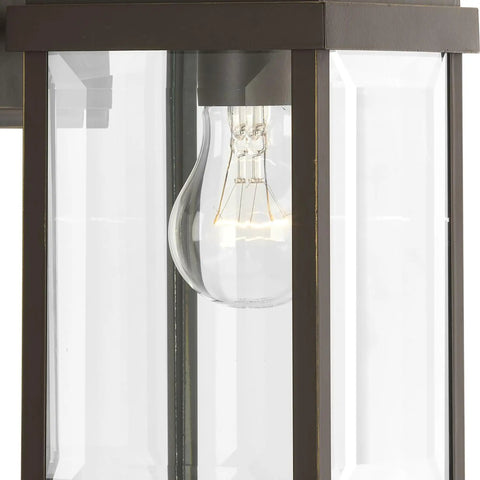 Close-up of Gibbes Street Collection 1 Light Outdoor Wall Lantern in Antique Bronze with clear beveled glass.