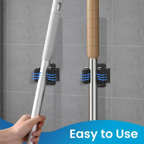 Heavy Duty Stainless Steel Broom And Mop Wall Mount Hanger, 4 Piece Set With Screws, mounted on a wall holding tools, black.