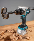 Badass 18V Brushless Drill Driver Boasting Killer Torque And A Slick Compact Frame With 21 Clutch Settings Plus Dual Speed Switches For Serious Trade Jobs Ahead, showing auger bit and wood shavings.