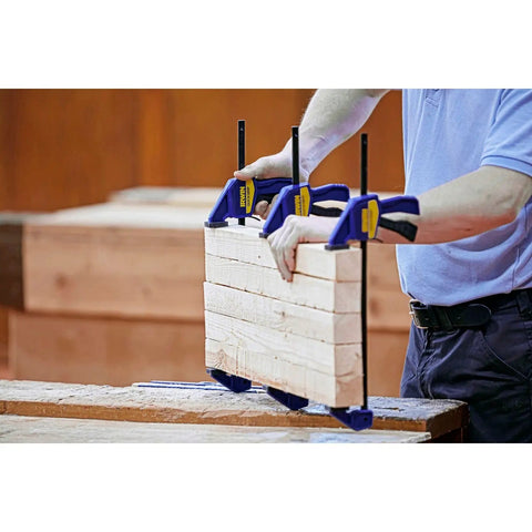 Six Inch Mini Bar Clamp Two Pack With One Hand Quick Release Trigger holding wood pieces firmly during woodworking project.