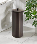Freestanding Bronze Toilet Paper Holder With Lid For Three Extra Rolls next to toilet in a modern bathroom setting