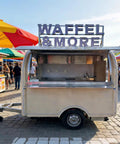Kickstart Your Mobile Eatery Hustle With This Custom Food Vending Trailer And Commercial Catering Cart featuring a mobile waffle food trailer with a stainless steel counter.