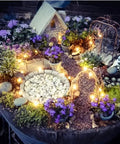 Miniature garden with warm white Solar String Lights 16 Feet 50 LEDs, illuminating pathway and plants at dusk.