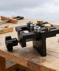 Heavy Duty Woodworking Doweling Jig Kit with Self Centering Anodized Aluminum Body on wooden table with clamps.
