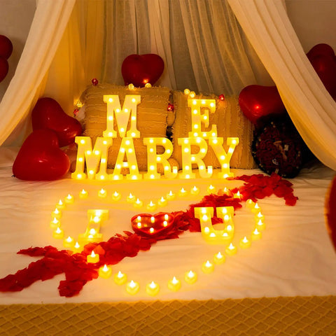 Romantic Marry Me Light Up Letters Proposal Kit with 7 letter signs, LED tea lights, burgundy rose petals, and balloons scene.