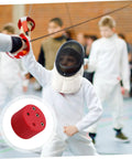 Child fencer practicing with Pro Grade Fencing Gear Testing Sensor and Electric Testing Station for high precision checks.