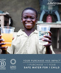 Smiling child holding two cups, one with dirty water, showcasing the impact of Peak Series Personal Water Filter For Hiking, Camping, Travel, And Emergency Prep, Trail Ready Filtration Removes 99.999999 Percent Bacteria, Parasites, And Microplastics, 1 Pack Mountain Blue.