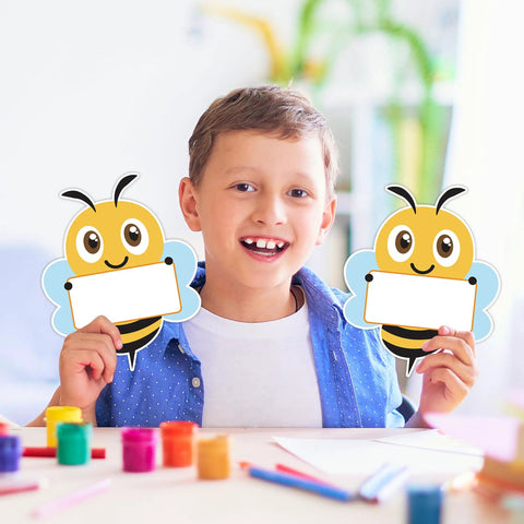 Child holding Bee Cutouts For Classroom Decorations 50 Pack Name Tags And Desk Nameplates Cute Bee Style Labels For Cubbies 5.9 By 4.7 Inches