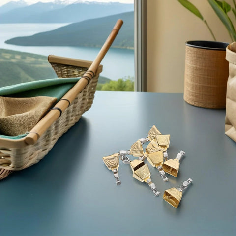 Stainless steel fishing bite alarms with clips on a table, ideal for freshwater and saltwater use, enhancing early bite detection.