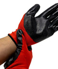 Person wearing red and black protective gloves adjusting them on wrist